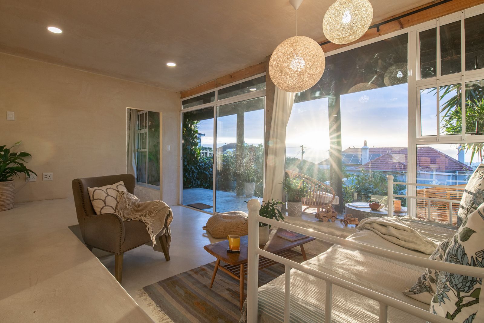 Sunroom at sunset, the sea beyond the glass